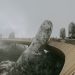 Stunning view of Golden Bridge held by stone hands enveloped in mist, Ba Na Hills.